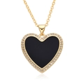 Close-up of gold heart pendant with black enamel center and sparkling zircon stones - Black Style (F152)