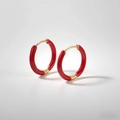 Close-up of red enamel hoop earrings with gold-plated hinge clasp on white background - Carmine Red