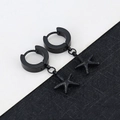 Close-up of black starfish charm earrings with textured matte finish on dark background - Small Starfish - Black