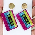 Close-up of retro 90's cassette tape earrings with colorful glitter acrylic finish - Retro Colorful Cassette