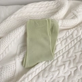 Breathable mid-calf cotton socks in light grass green with ribbed cuffs on knit blanket - Green
