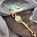 Detail of gold-tone women's watch with horsebit design and elegant white oval dial - Gold White