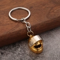 Creative golden metal motorcycle helmet keychain with a silver-toned split ring - Gold