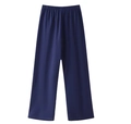 Detail view of navy blue wide-leg trousers with elastic waistband on white background - Blue Pants
