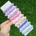 9-piece set of pastel elastic scrunchies on a display card held over green grass - 9Pcs Purple Blue Pink