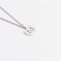 Detail of silver pumpkin lantern pendant with carved face on a stainless steel chain - Silver