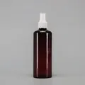 Detail of amber PET spray bottle with white fine mist pump and transparent cap - 300ml / Amber Bottle