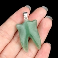 Green natural quartz tooth-shaped pendant with silver clasp on black background - Green Aventurine