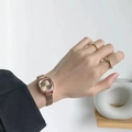 Elegant gold mesh strap watch for women displayed on a wrist with minimalist decor - Rose Gold Case Coffee Dial