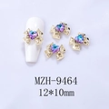 Macro shot of 12x10mm alloy bow nail charms with central heart-shaped crystal rhinestones - Gold Base Starry Pink Purple Heart (9464)