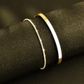 Men's double-layered gold snake chain and C-shaped cuff bracelet on a black display stand - Gold C-Bangle + Box Chain