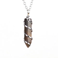 Detailed close-up of tiger eye hexagonal stone with silver spiral wire wrap - Silver + Tiger's Eye