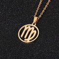 Golden Virgo zodiac pendant necklace in stainless steel on a textured black background - Virgo / Gold