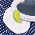 Detail shot of a realistic green lime slice hair clip with textured fruit pulp design - Half Lime Slice