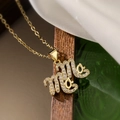 18K gold plated necklace with zircon MAMA cursive pendant on elegant dark wood setting - Cursive Mama