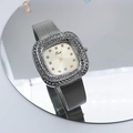 Macro detail of square silver watch with mesh band and double row of crystal accents - Gold Dial