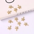 Macro shot of 10 golden starfish charms with cubic zirconia for DIY jewelry making - Five-petal Flower 9*11mm