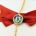 Golden bracelet with round abalone shell pendant featuring the letter O on red ribbon - Letter O