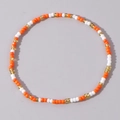 Fashionable handmade beaded bracelet featuring orange, white, and gold seed beads in a vibrant style - Orange White Gold