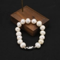 Elegant natural pearl bracelet featuring a silver bean-shaped clasp on a black background - White Freshwater Pearl Set Bracelet