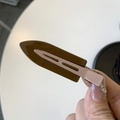 Detail of vintage bicolor resin hair clip showing the metallic duckbill clamp mechanism - Dark Brown & Khaki