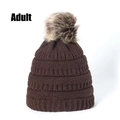 Detail of dark brown knit beanie with thick texture and fluffy faux fur pompom for adults - Coffee