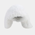 Close-up of white plush faux fur texture on warm winter hat with fluffy ear flaps - White