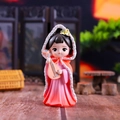 Macro shot of a Q-version ancient Chinese girl figurine with pipa in orange hanfu - Wang Zhaojun (Tang Style)