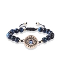 Macro shot of blue tiger eye beaded bracelet featuring a gold-plated evil eye charm - Blue