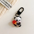 Detailed shot of cute panda keychain holding a red table tennis racket with black metal clasp - Panda-Table Tennis