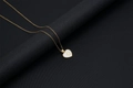 Macro detail of 18k gold heart necklace with white mother of pearl inlay and letter D - Shell Heart Letter D (With Chain)