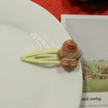 Cute gingerbread man Christmas hair clip with yellow metal base on white plate background - Beige Gingerbread Man Hair Clip