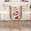 Weihnachtliche Stuhlhussen mit Weihnachtsmann im Schornstein und Karomuster-Rand - Weihnachtsmann Schornstein Stil / Schwarz Weiße Karo Stuhlhusse
