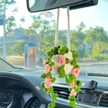 Crocheted car mirror hanging plant with pink flowers and green leaves in white pot - White Basket + Pink Flowers