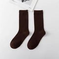 Single pair of dark brown cotton crew socks with ribbed knit texture in a flat lay view - Coffee