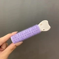 Purple and white hair root clip volumizer roller held against a neutral gray background - 1 Pc / Purple