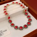 Vintage gold choker necklace featuring red flower charms with black crystal borders - Red Necklace