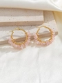 Detail of bohemian gold hoop earrings with handmade pink natural crystal stone wrapping - Pink