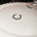 Detailopname van een zilveren dubbellaagse oorklem met zirkoon op een wit bord - 53# Ring-Zilver