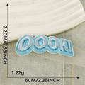 Light blue embroidered patch with OOOK! lettering measuring 6cm by 2.2cm for DIY crafts - OOOK! Light Blue