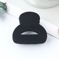Minimalist black flocked hair claw clip with matte texture and hollow oval design - Flocked Black