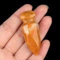 Handheld tiger eye stone dagger carving showing natural orange textures and sharp edges - Yellow Jade