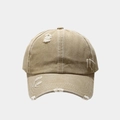 Detailed view of the distressed khaki baseball cap with white stitching and frayed edges - Adjustable / Khaki