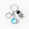 Detail of silver astronaut pendant and blue planet glass dome on key ring - Dark Blue Hemisphere-11