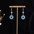 Detail of light blue translucent round earrings with golden hooks and pearl fringe style - E3997 (Gold/Light Blue Geometric Round)