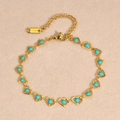 Detalle macro de la pulsera de corazón en acero dorado con cuentas turquesas y cierre - Estilo Corazón Turquesa (1899GL)