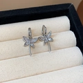 Silver dragonfly earrings with marquise-cut zircon wings on a beige velvet background - Dragonfly Shaped Zirconia Drops (70#)