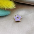 Close-up of purple five-petal flower pendant with gold edges on silk for DIY jewelry - Lavender