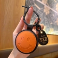 Oranje lederen smiley sleutelhanger met zwarte metalen sluiting voor damestassen - Leer-Oranje Glimlach