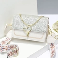 Elegant white crossbody bag with silver glitter lid, gold heart lock, and ethnic strap - 21x8x14cm / White